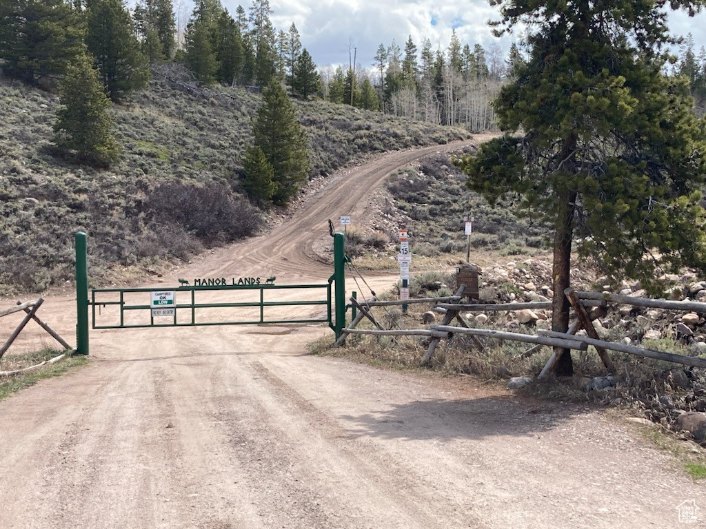 View of road featuring a rural view and a gate