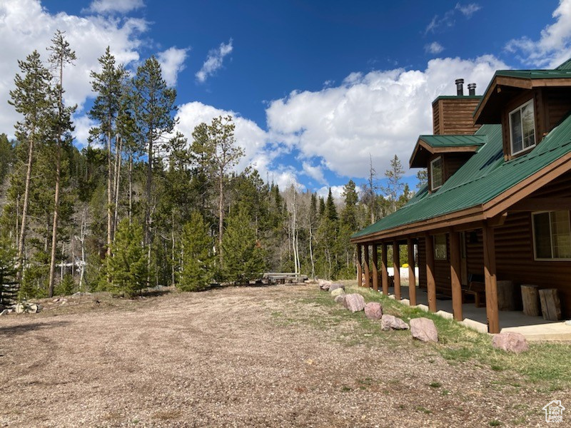 View of yard with a view of trees