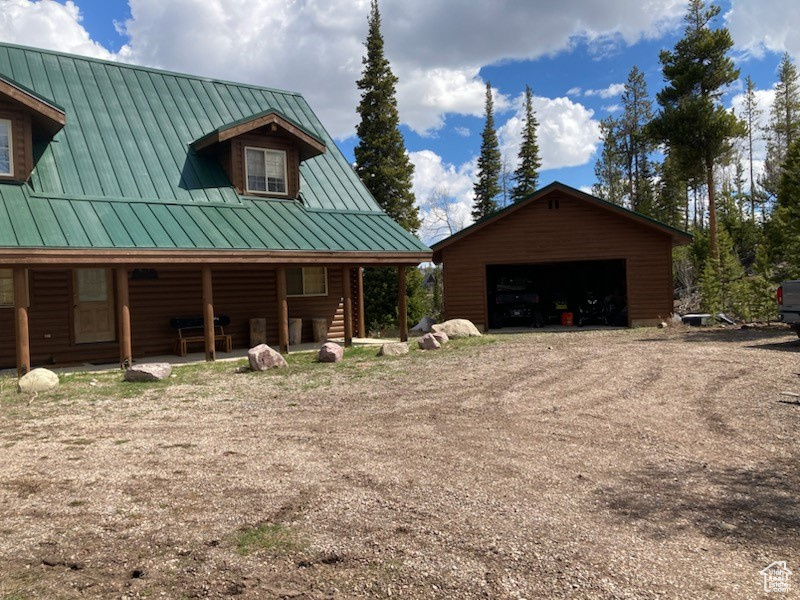 View of front of house with metal roof, an outbuilding, a standing seam roof, and a garage