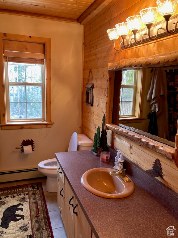 Bathroom featuring toilet, tile patterned floors, wooden ceiling, wooden walls, and baseboard heating