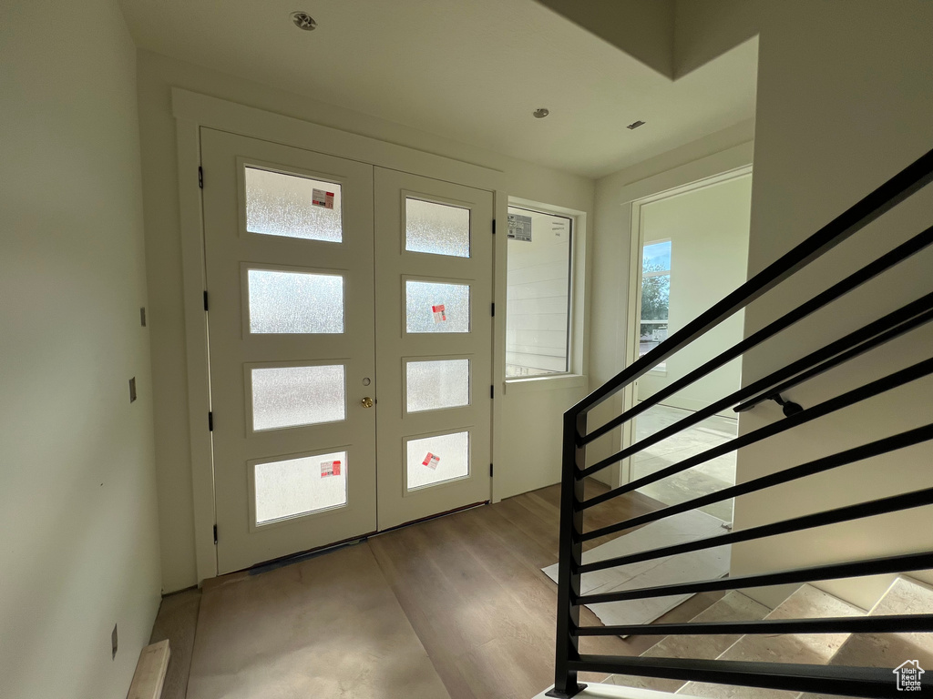Entrance foyer featuring stairway and wood finished floors
