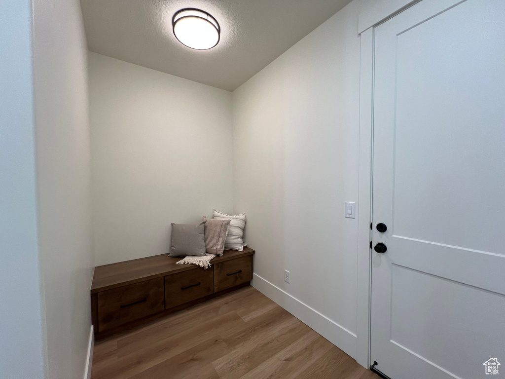 Mudroom featuring light wood-type flooring and baseboards