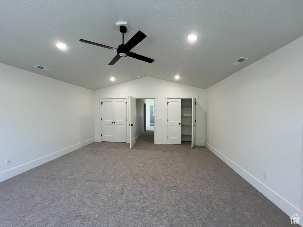 Unfurnished bedroom with recessed lighting, vaulted ceiling, carpet floors, multiple closets, and ceiling fan