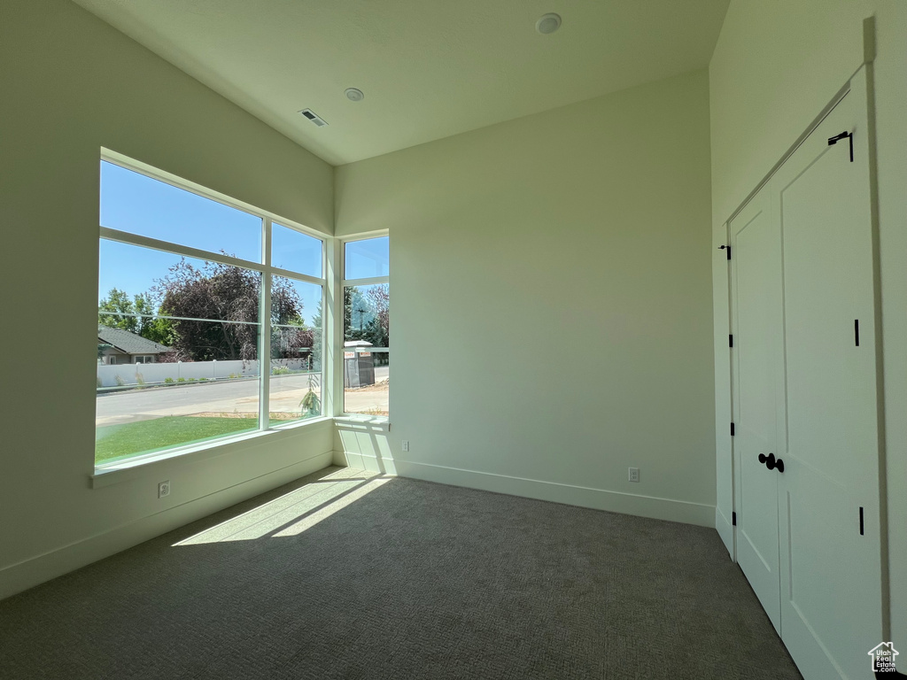 Unfurnished bedroom featuring carpet floors and baseboards