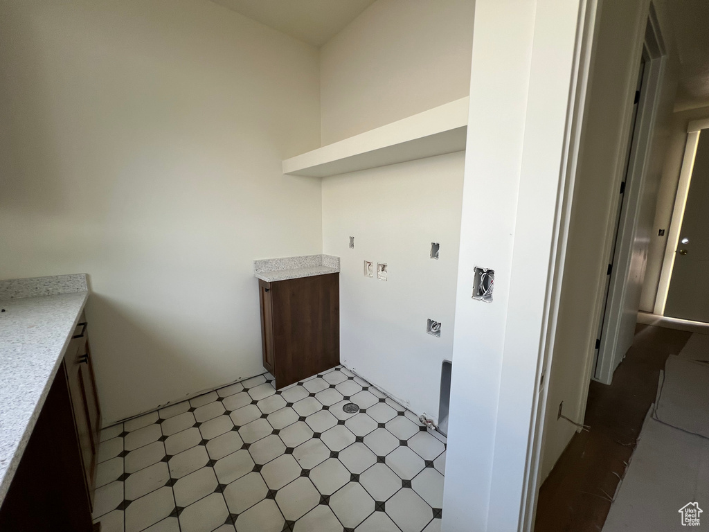 Laundry room featuring light floors