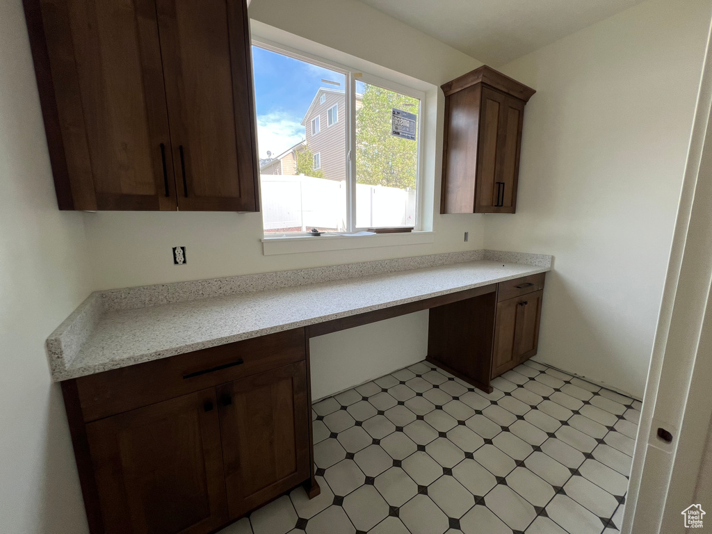 Kitchen with light floors and built in study area