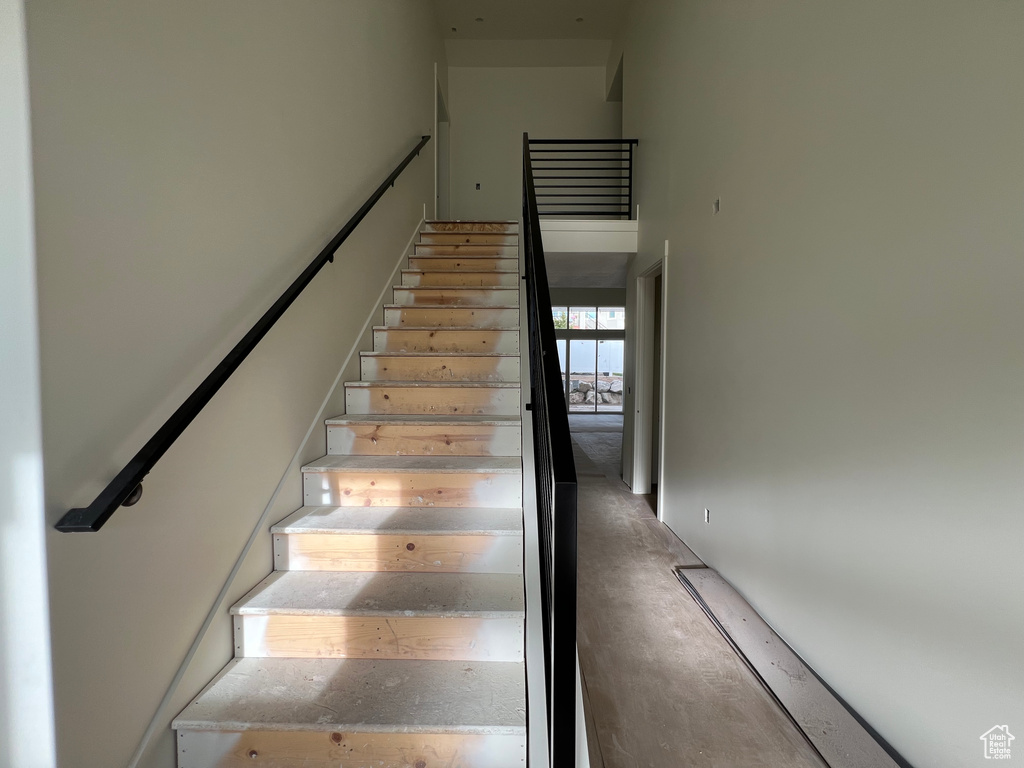 Stairway with a towering ceiling