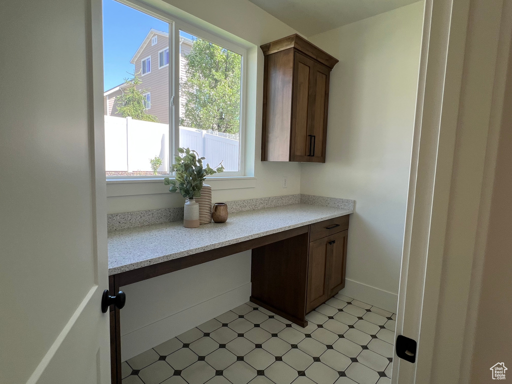 Kitchen with healthy amount of natural light, light flooring, and light stone countertops
