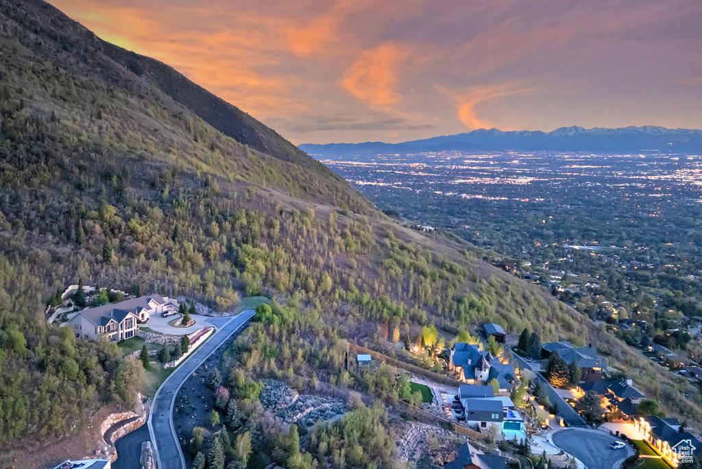 Aerial view at dusk with a mountain view and a wooded view