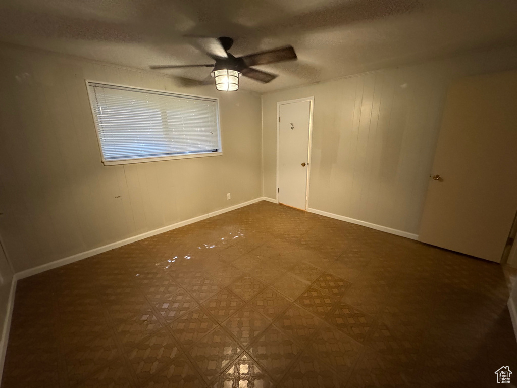 Spare room featuring ceiling fan, a textured ceiling, and baseboards
