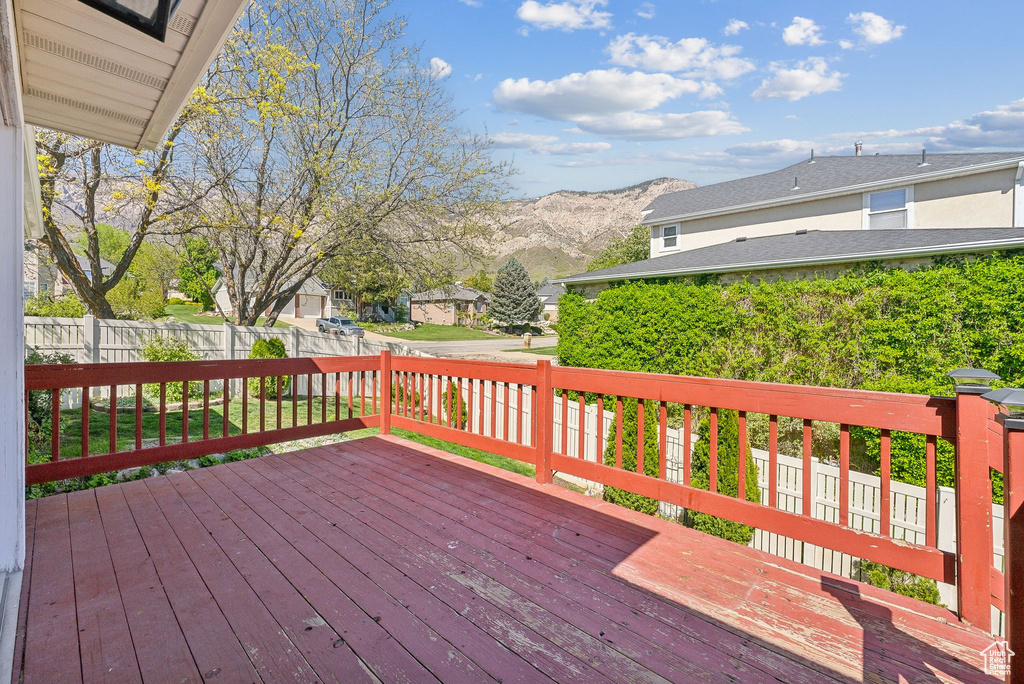 Wooden deck with a mountain view and fence