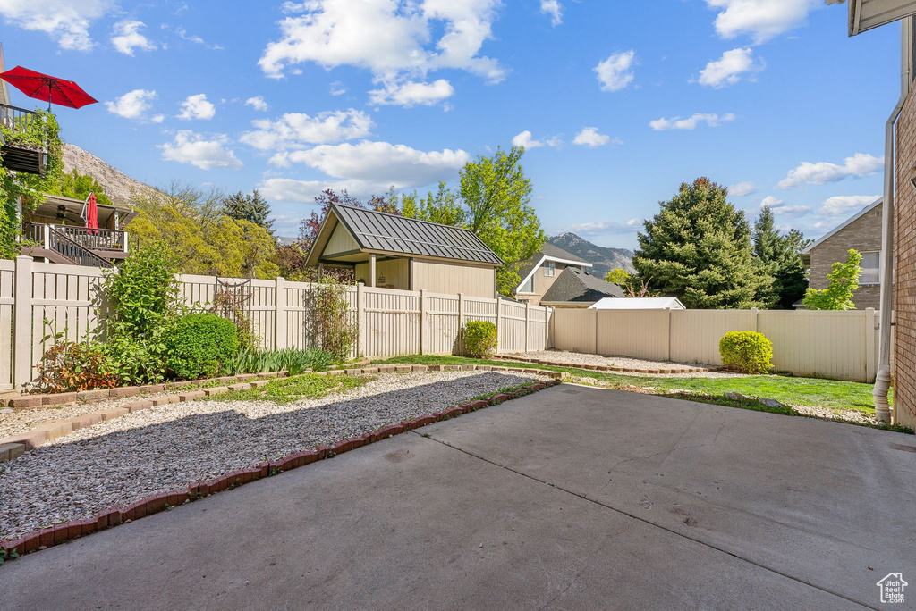 View of patio featuring a fenced backyard and a mountain view