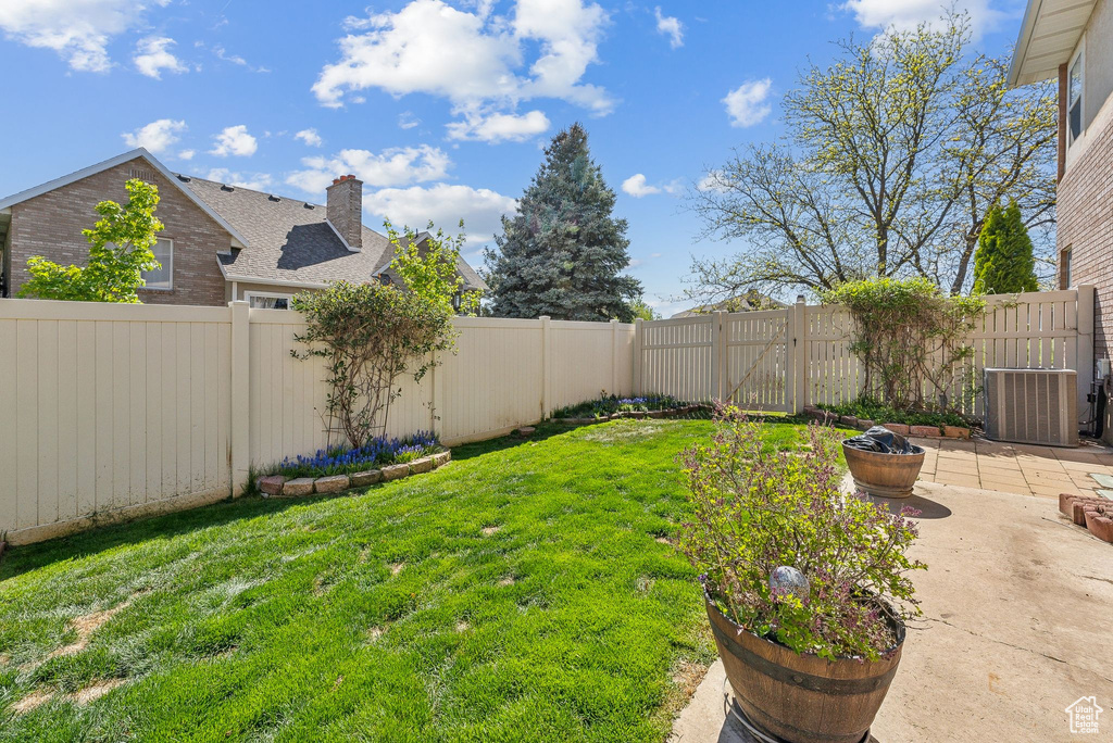 View of yard featuring central air condition unit, a patio, and a fenced backyard