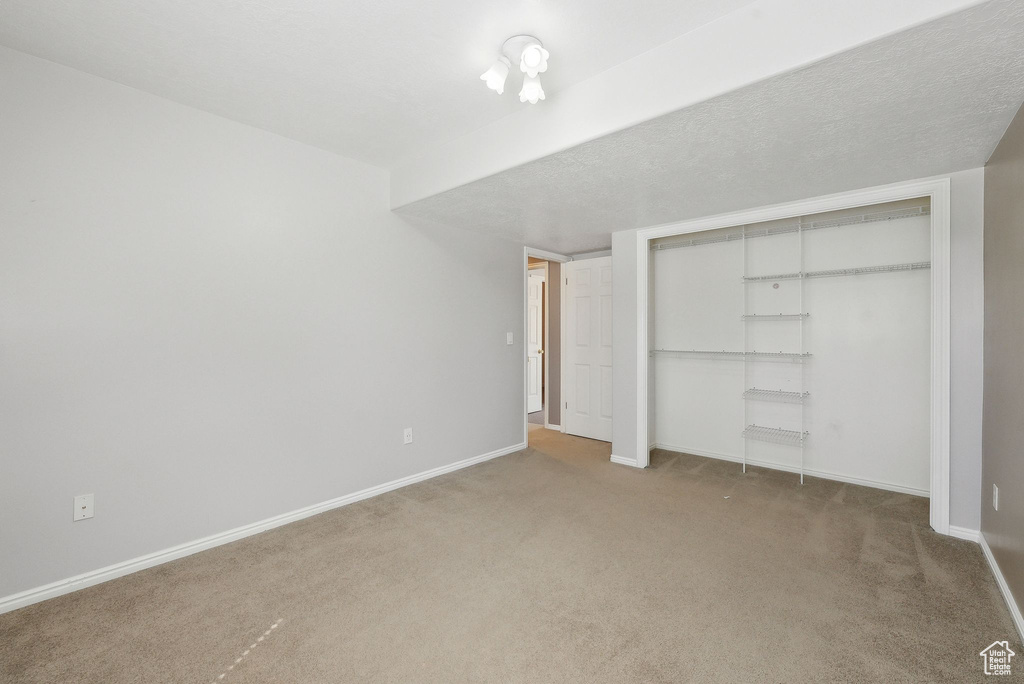 Unfurnished bedroom with a closet, baseboards, and carpet floors