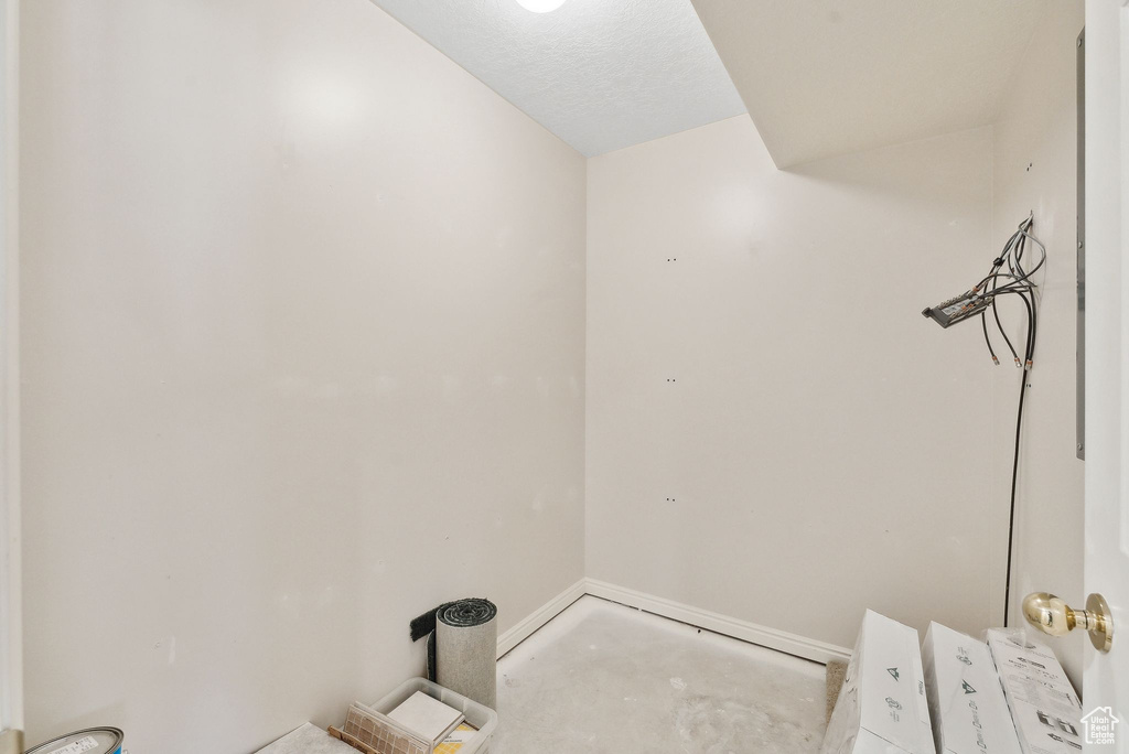 Bathroom with baseboards and unfinished concrete flooring