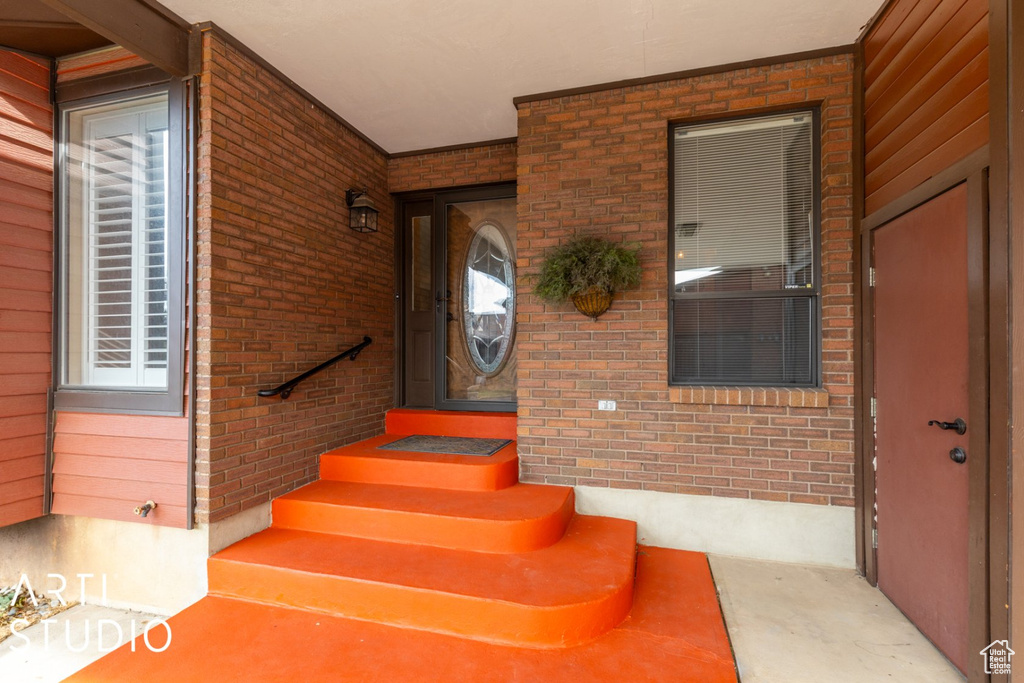 Staircase with concrete floors and brick wall