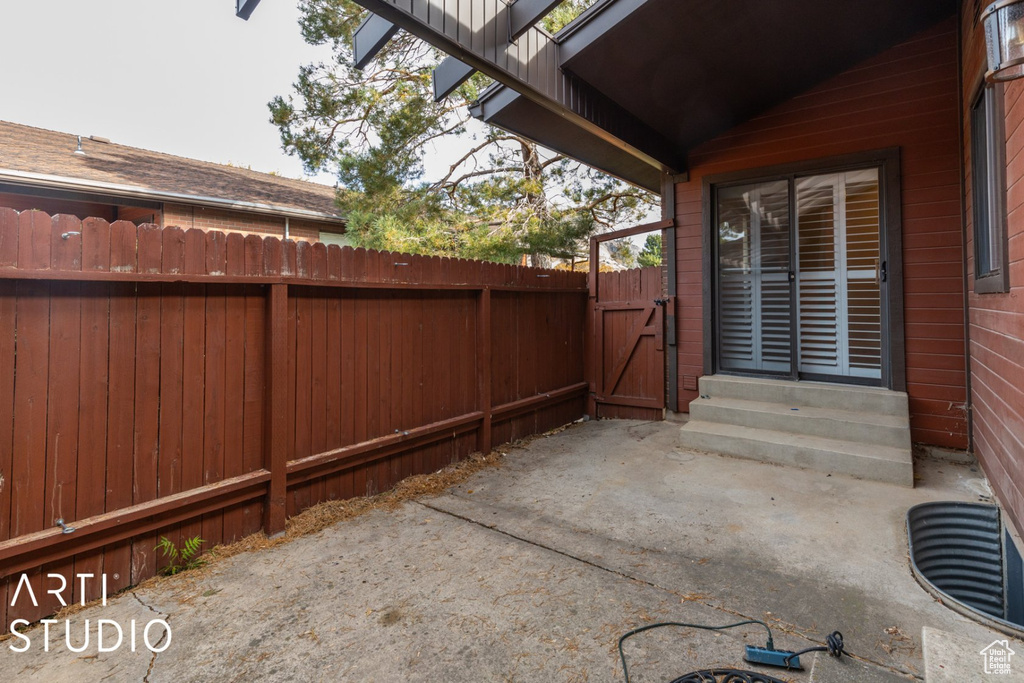 View of patio / terrace featuring a gate, fence, and entry steps