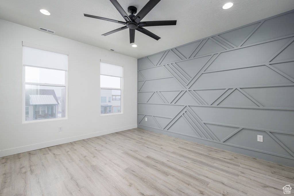 Spare room with visible vents, wood finished floors, a ceiling fan, and recessed lighting