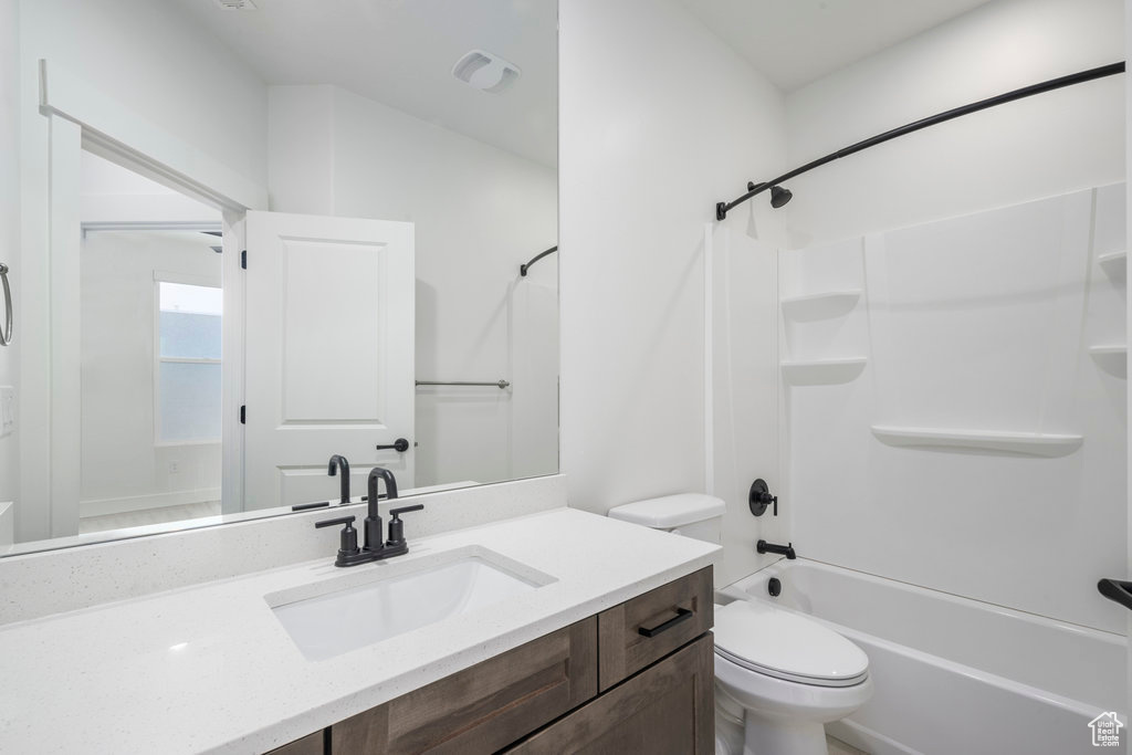 Bathroom with vanity, toilet, and tub / shower combination