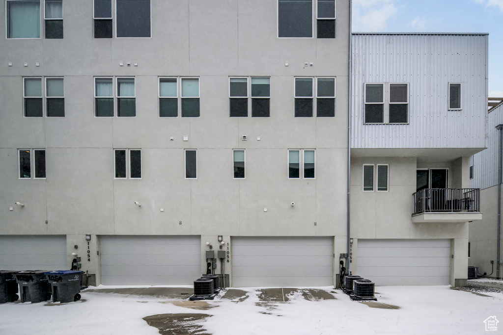 Exterior space with an attached garage and cooling unit