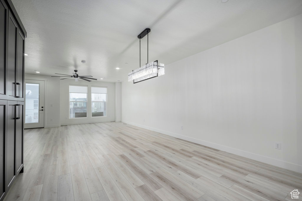 Interior space with light wood-style flooring, baseboards, and recessed lighting
