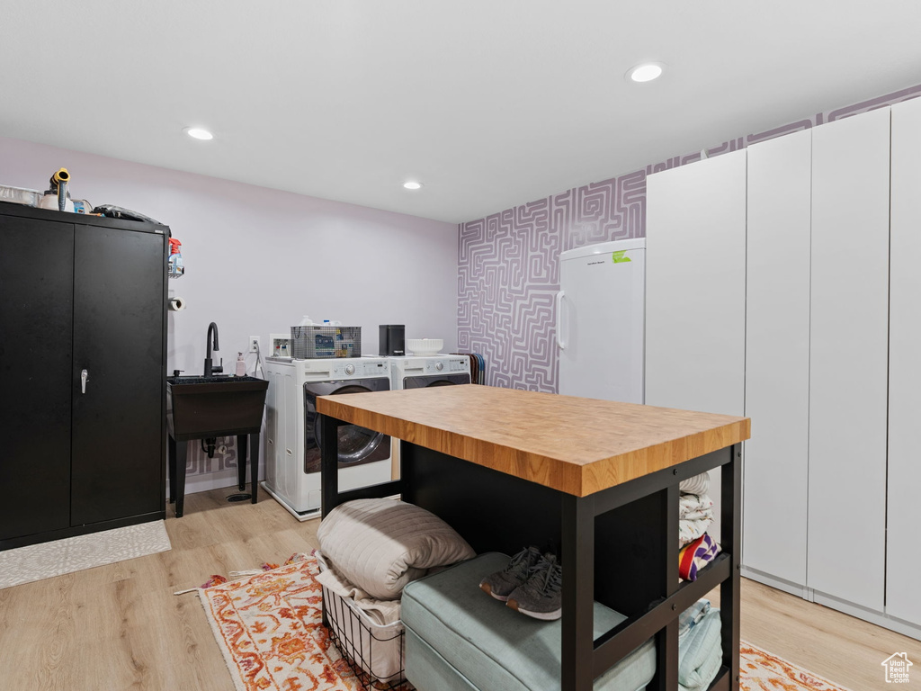 Interior space featuring recessed lighting, washing machine and dryer, and light wood-style floors