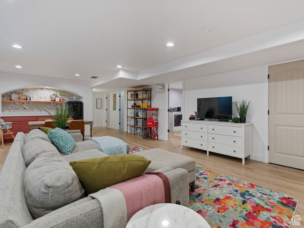 Living room with recessed lighting, baseboards, and light wood-type flooring