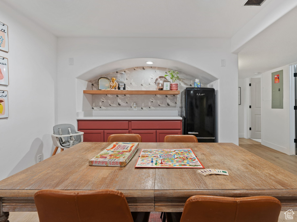Dining room with baseboards and light wood-type flooring