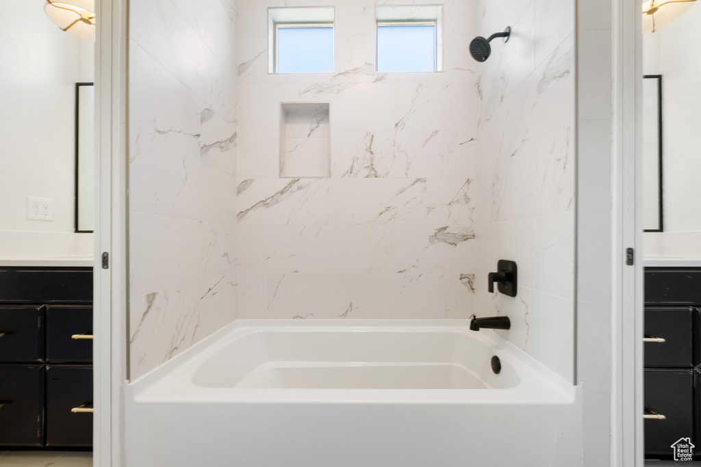 Bathroom featuring  shower combination and vanity