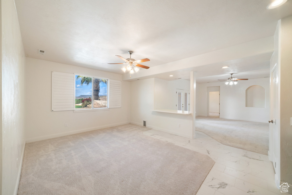 Spare room with recessed lighting, baseboards, marble finish floor, ceiling fan, and light carpet