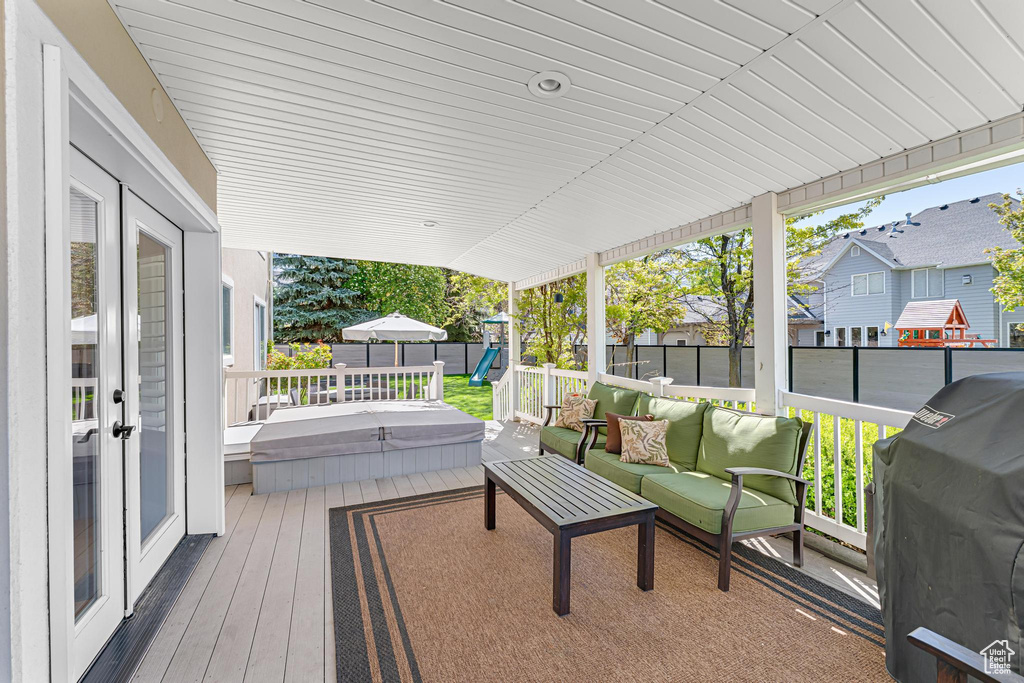 Deck featuring grilling area, outdoor lounge area, a residential view, and a fenced backyard