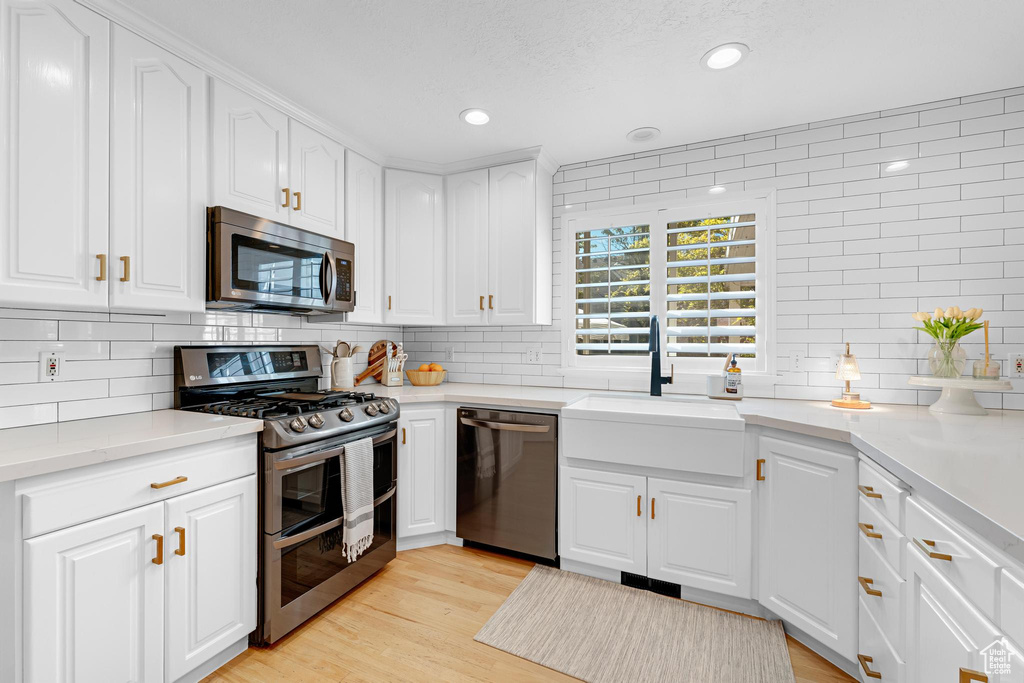 Kitchen featuring recessed lighting, a sink, appliances with stainless steel finishes, and backsplash