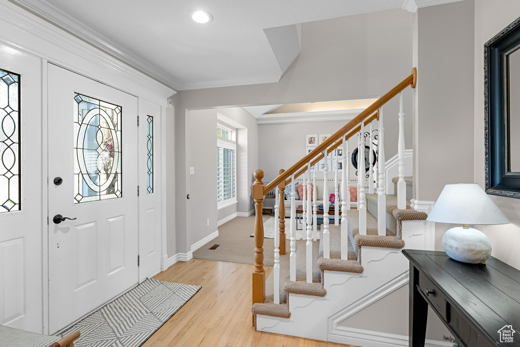 Entryway featuring crown molding, recessed lighting, stairway, and light wood-type flooring