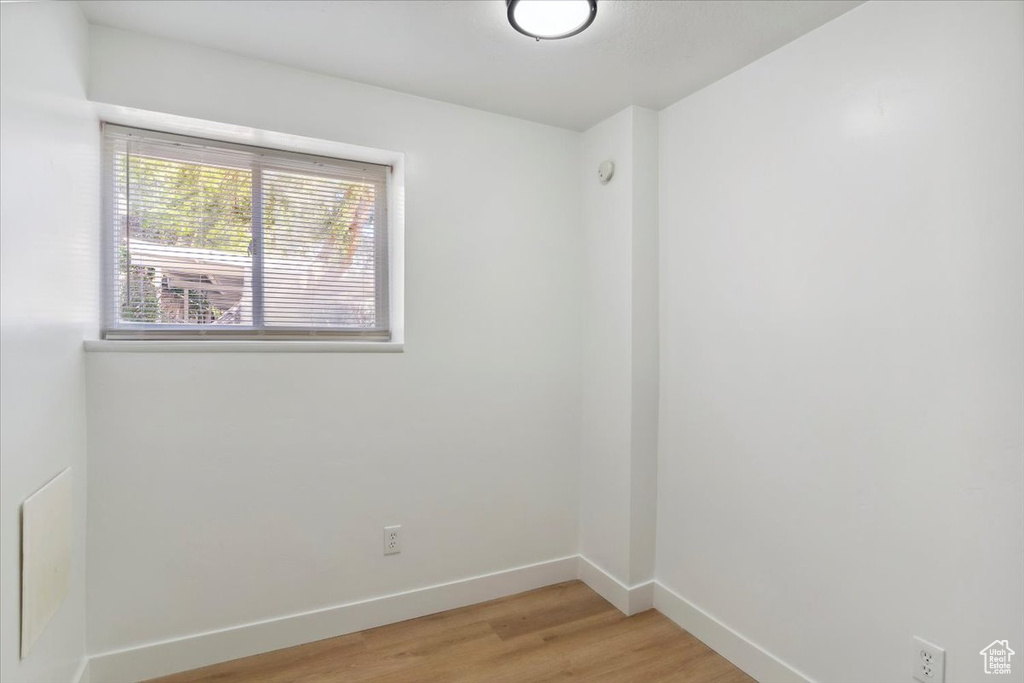 Unfurnished room featuring baseboards and light wood-type flooring