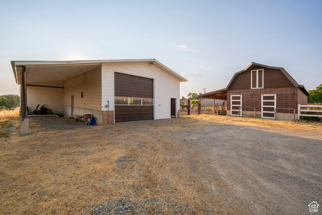 Garage with fence and driveway
