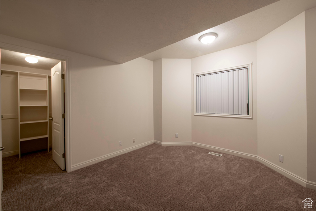 Unfurnished bedroom featuring visible vents, baseboards, a closet, a spacious closet, and carpet flooring