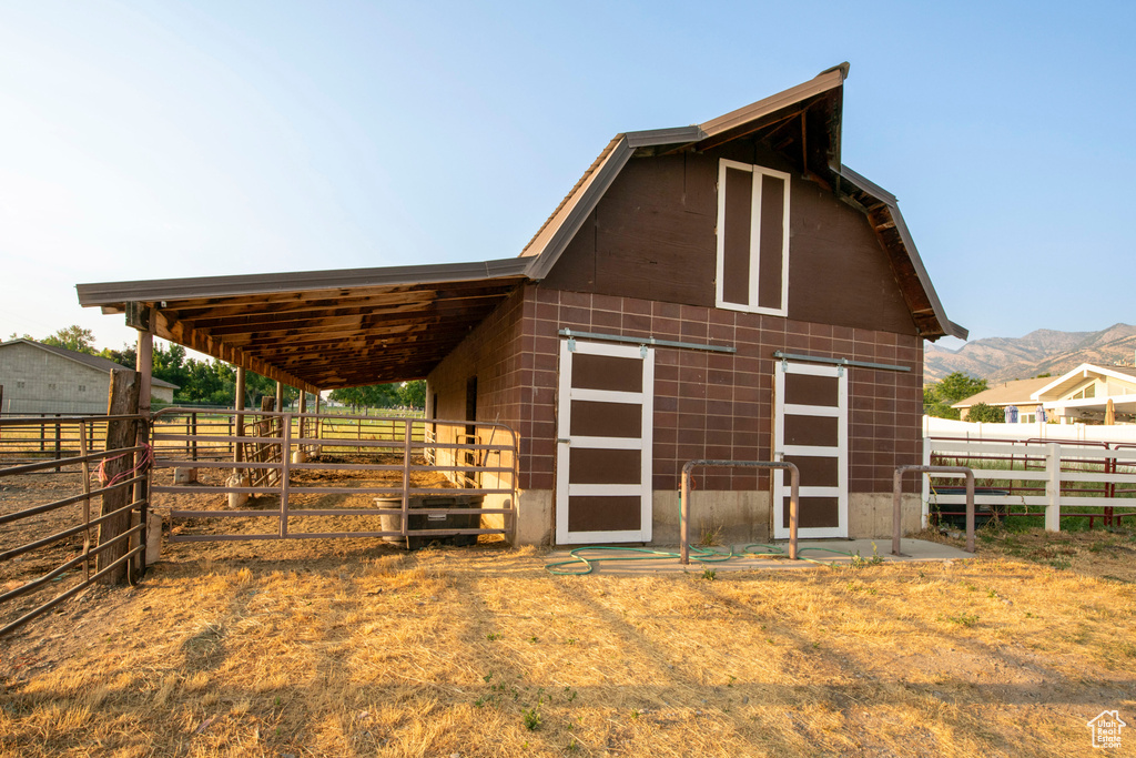 View of outbuilding featuring an exterior structure, a mountain view, and an outdoor structure