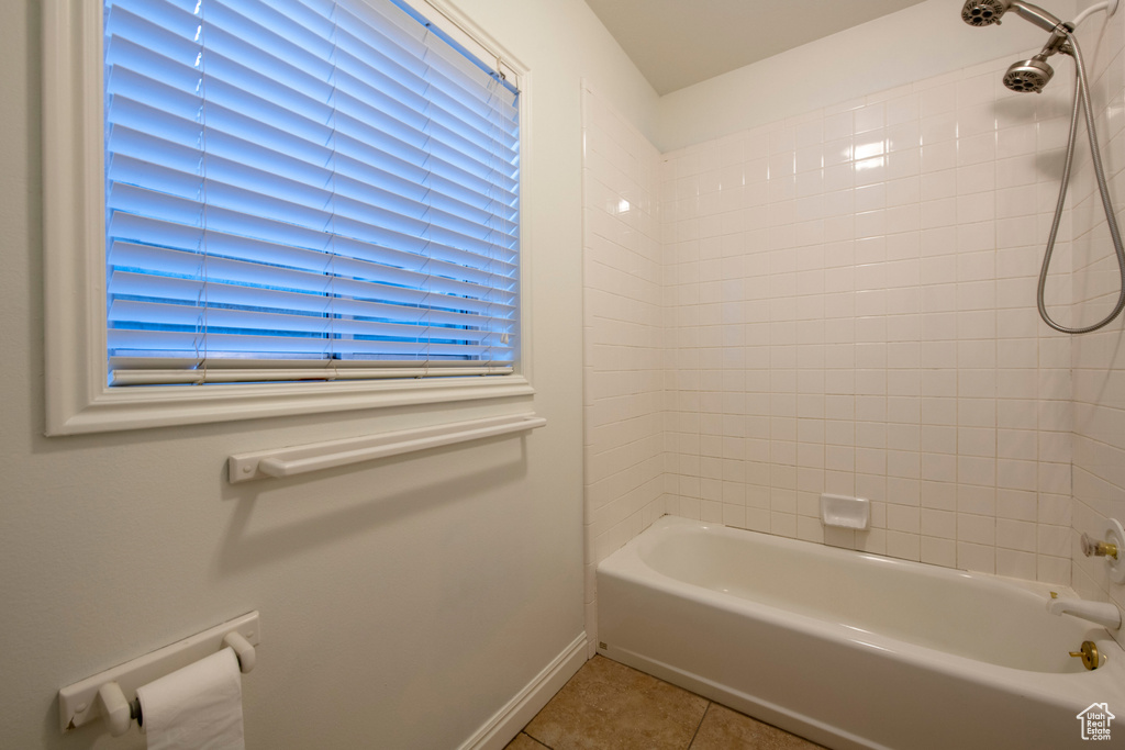 Bathroom with tile patterned flooring, baseboards, and shower / bathing tub combination