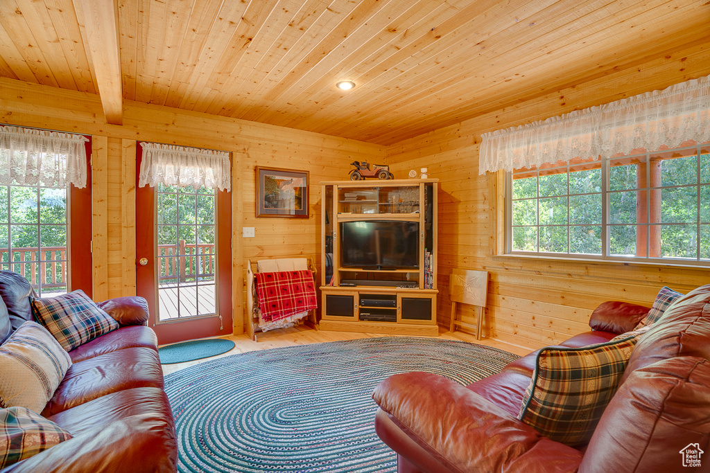 Living area with wood ceiling, wooden walls, wood finished floors, and recessed lighting