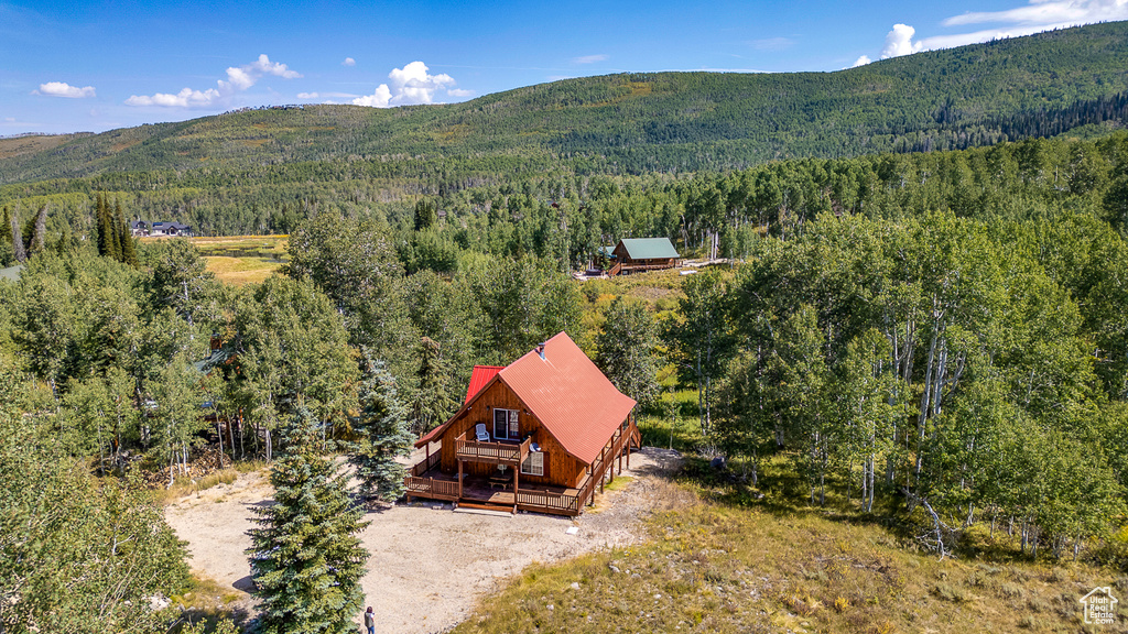 Birds eye view of property featuring a forest view and a mountain view