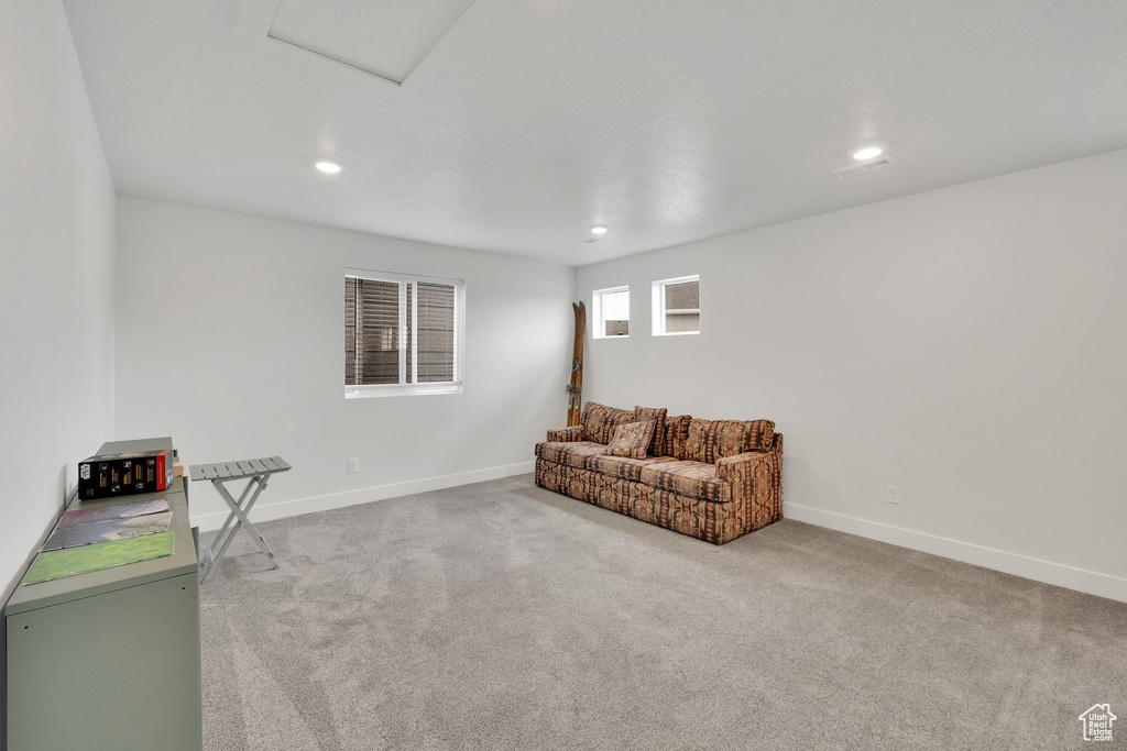 Carpeted living room with attic access, baseboards, and recessed lighting