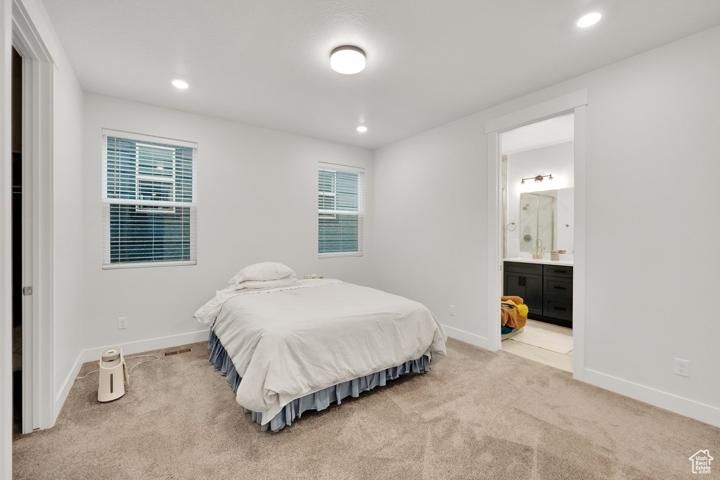 Bedroom with light colored carpet, baseboards, and recessed lighting