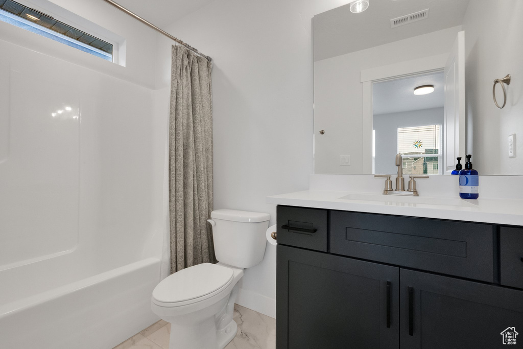 Full bathroom featuring toilet, shower / tub combo with curtain, visible vents, marble finish floor, and vanity
