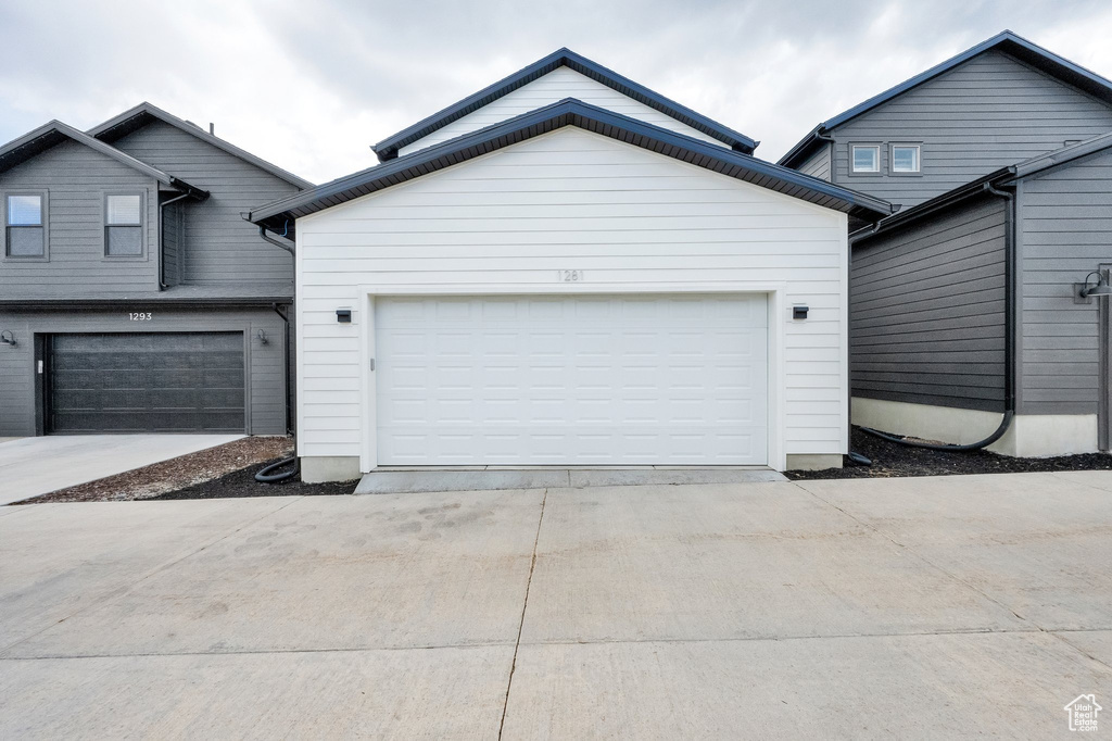 Garage featuring concrete driveway