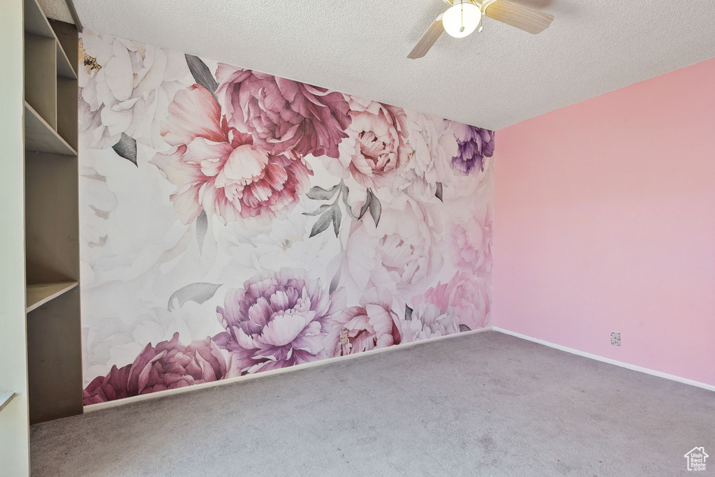 Unfurnished room with carpet flooring, a textured ceiling, and ceiling fan