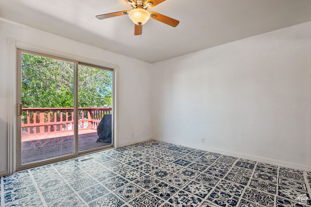 Spare room featuring ceiling fan and baseboards