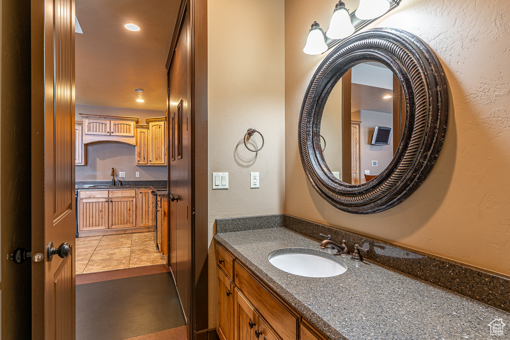 Bathroom with vanity and a textured wall