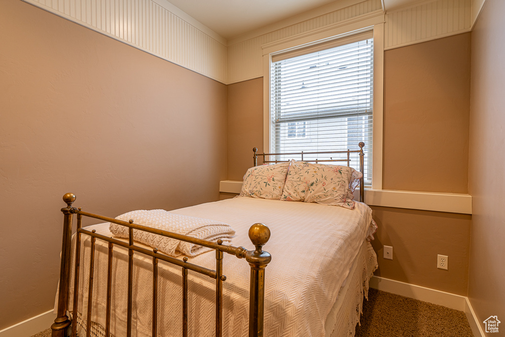 Bedroom with carpet flooring and baseboards