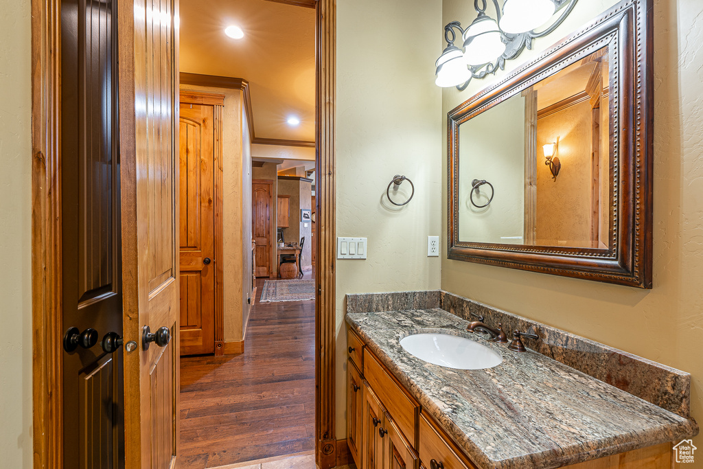 Bathroom featuring vanity and wood finished floors