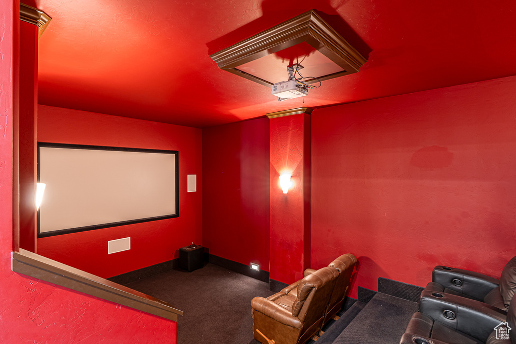 Carpeted cinema room with baseboards
